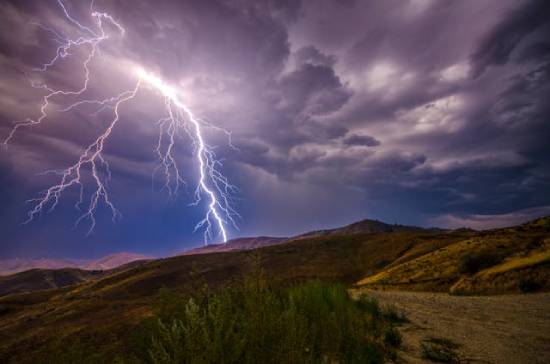Lightning striking a mountaintop.