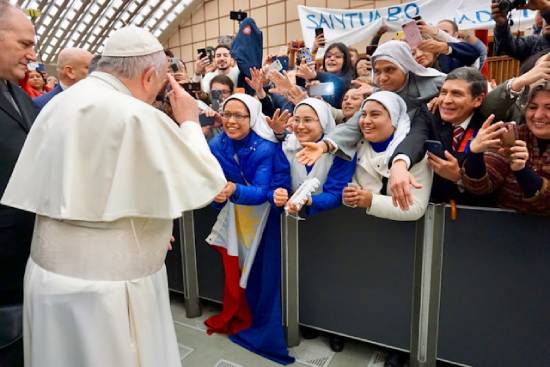 Pope Francis Surrounded with many people Pope Francis greeting a crowd. The Pope has the highest authority in the Catholic Church.