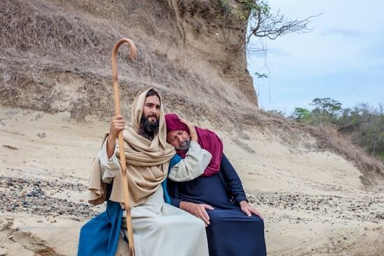 Jesus with a man needing help Jesus sitting with a man and putting his arm around him in comfort