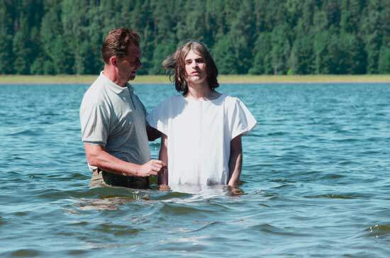 Baptism in river A man baptizing a boy in a river, just as John the Baptist baptized people in the Jordan River