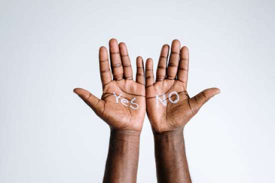 Hands with Yes and No Choices Hands help up with the words yes and and no written on each one