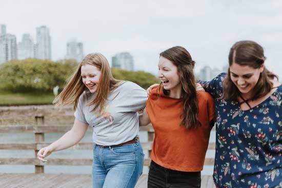 Girls laughing Three girls with their arms around each other, laughing, to remind us of the New Jerusalem where all tears and sorrow will be wiped away