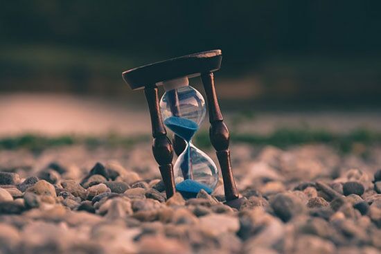 An hourglass with the sand An hourglass with the sand half emptied through the middle