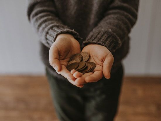 Person with coins in hands Outstretched hands cupped, holding a few coins, signifying that even the smallest amount can be multiplied by God according to His purpose.