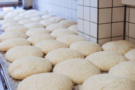 Dough on a Tray in a Bakery Bread dough set out to rise, illustrating the parable of the leaven