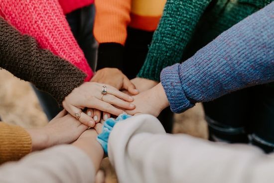 Hands piled together Hands piled together in harmony, just like the Bible writers harmonized through the Holy Spirit