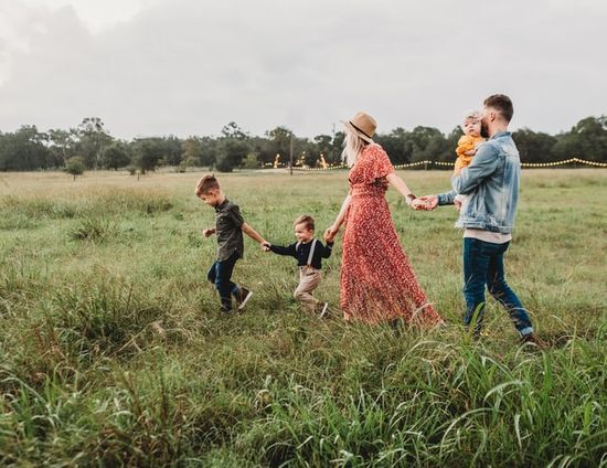 Family strolling through a field A family strolling through a field to relax