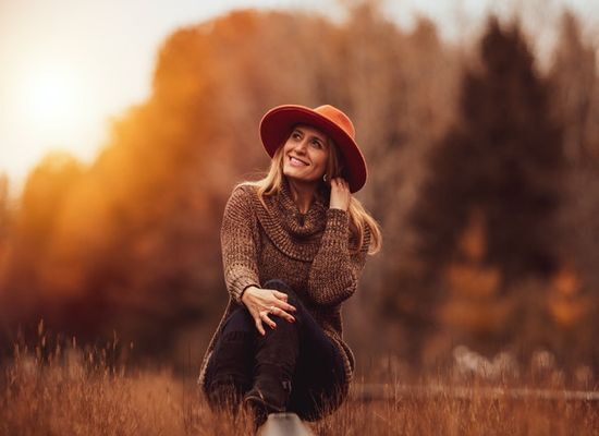 Sunlight Outside A woman sitting in a field at sunset, getting the last bit of sunshine