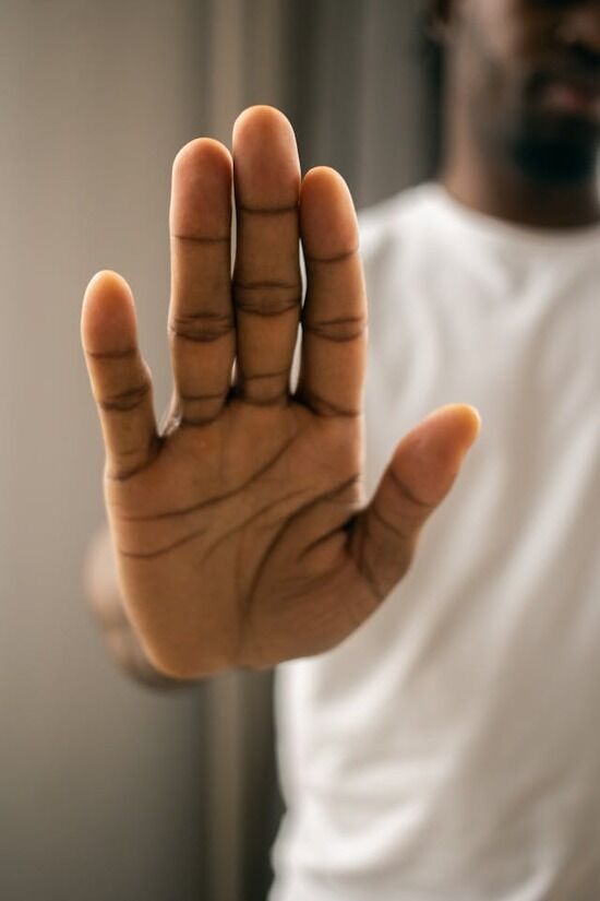 A hand A man holding his hand out to tell someone to stop