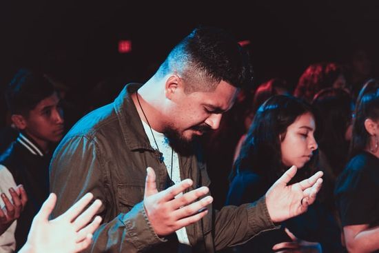 People praying People praying and lifting their hands to God at an evangelistic campaign