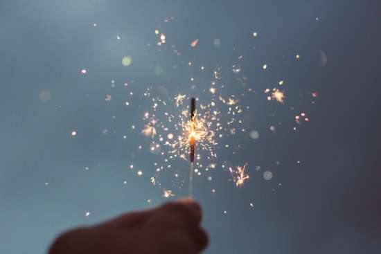 Lighted Sparkler Celebrating Holidays A hand holding a sparkler to celebrate a holiday