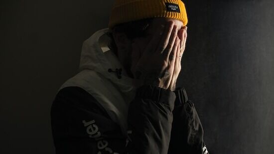A Man Worried about His Sin A man with his hands on his face, mourning his sin