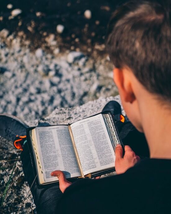 Reading Bible A man reading the Bible to find assurance about end-time events