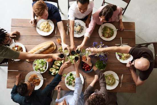 Family enjoying Easter dinner together A family sitting around a table eating Easter dinner
