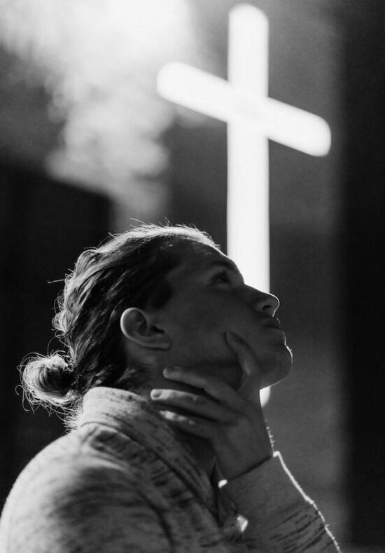 Looking at Cross A woman looking at the Cross and considering Jesus Christ and His sacrifice for her