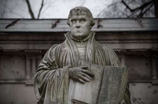 Martin Luther and Sola A statue of Martin Luther holding the 95 Theses