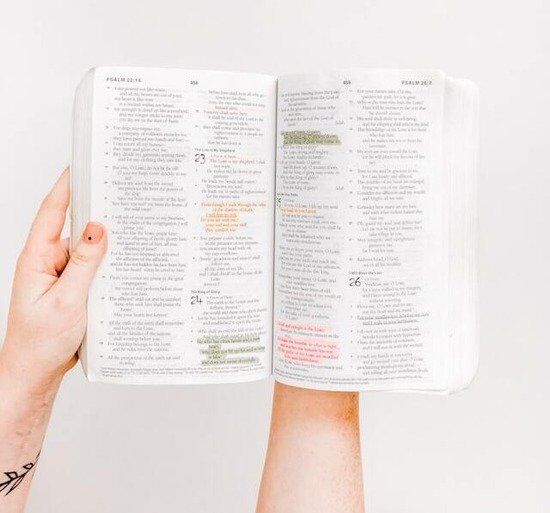 Open Bible A hand holding an open Bible and claiming God's promises to resist temptation