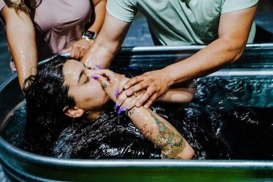 Immersion Baptism A woman being baptized by immersion to become a member of the Seventh-day Adventist Church
