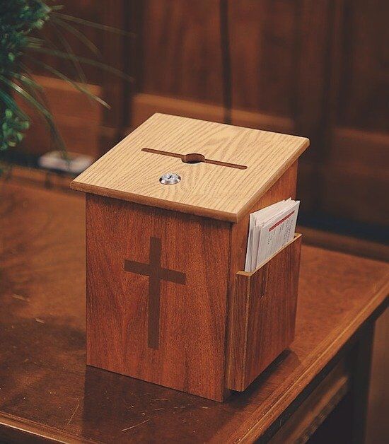 Tithe Collection Box A wooden offering and tithe collection box at a Seventh-day Adventist Church