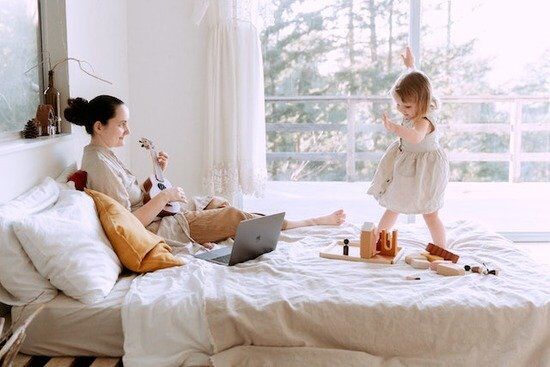 Playing Ukulele for Daughter A mother playing the ukulele for her daughter