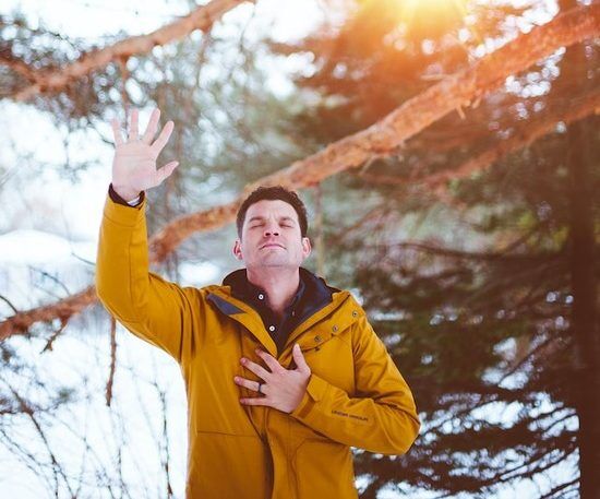 A man raising his hand in prayer and worship