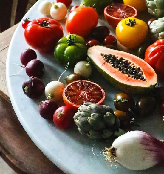 Fruits and Vegetables on the Table A platter of delicious fruits and veggies.