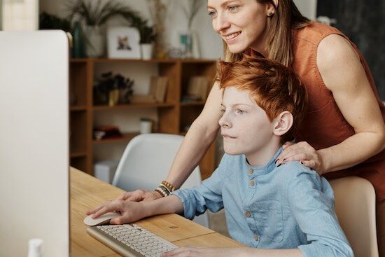 Searching Online A mother and son searching online for an Adventist private school