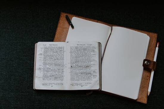Greek Bible Septuagint An old Greek Bible open on top of a notebook