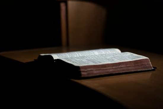 Open Bible An open Bible on a desk as someone studies about the lives of the disciples