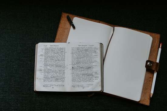 Greek Bible for Scholars A very old Greek Bible on top of a blank notebook