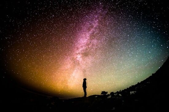 Looking into space A silhouette of a person standing and looking up into space