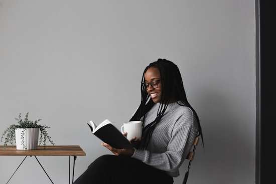 A woman reading a Bible A woman reading a Bible as a way to grow her relationship with Jesus