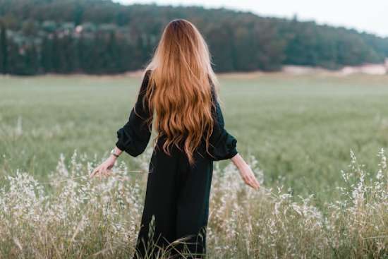 Modest Woman with long Hair and Dress in a Field Being modest is more than wearing a long, flowy dress. It's an attitude that lets the love of Christ flow out from us.