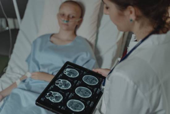 Doctor reviewing brain scans of a young patient A doctor reviews brain scans with a young patient, highlighting how people often request prayers for health and healing.