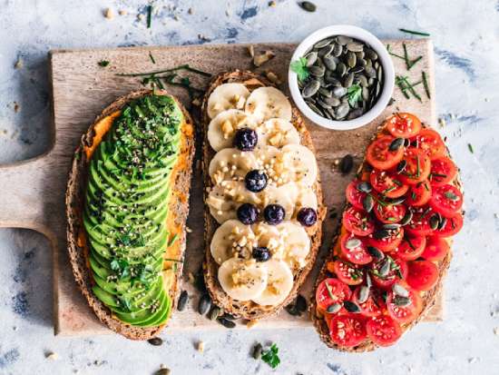 Healthy Toast Diet Adventist A healthy meal consisting of toasts with different toppings including avocado, tomatoes, and bananas.