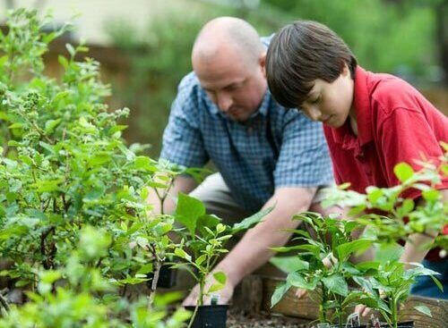 Adventist school instructor teaching students gardening skills as an emphasis on practical manual training