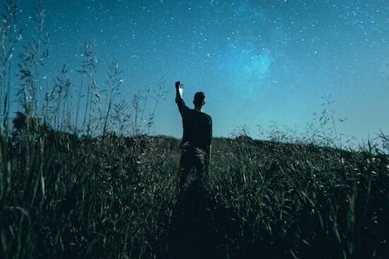 Man in field receiving vision from God A man under a starry sky, as though he might be a prophet receiving a vision