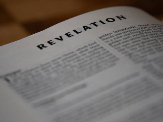 Bible open to the book of Revelation A Bible is open to the book of Revelation.