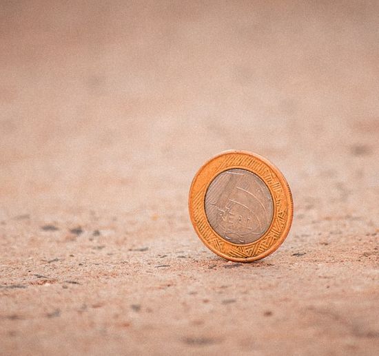 A coin balancing on its edge The lost coin on the ground, just like the one in the parable in Luke 15