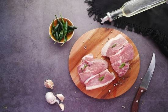 A cutting board with sliced meat