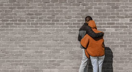A man hugging a woman in forgiveness.