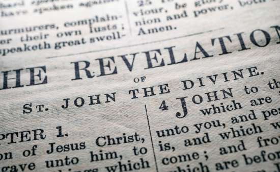Open Bible in the Book of Revelation A page from the book of Revelation written by the apostle John