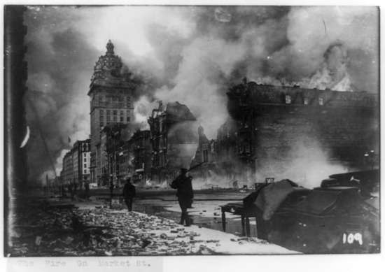 San Francisco Earthquake A black and white photo of a man patrolling the demolished streets of San Francisco after an earthquake.