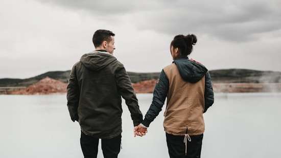 Couple holding hands outdoors A man and woman holding hands.