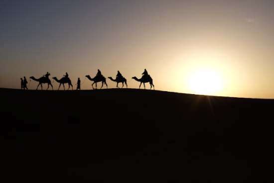 Wise men magi journey A group of men ride camels across the desert, representing the journey the Wise Men took through the desert to see Jesus.