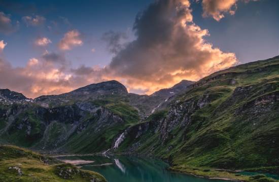 A lush mountain with a waterfall.