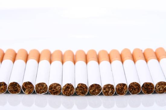 A stash of cigarette sticks A row of cigarettes, which is one way people use tobacco.