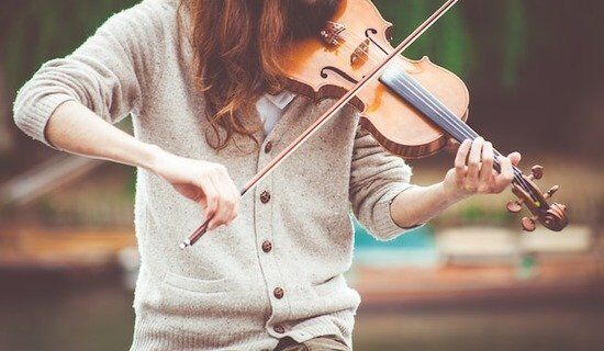 Woman Playing Violin A woman playing a violin to make music that honors God