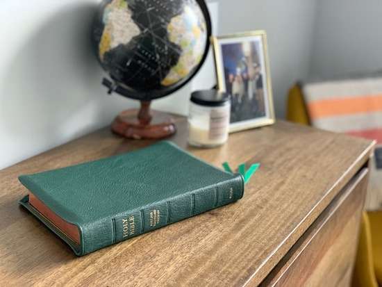 Protestant Bible on Desk A green Protestant Bible on a desk