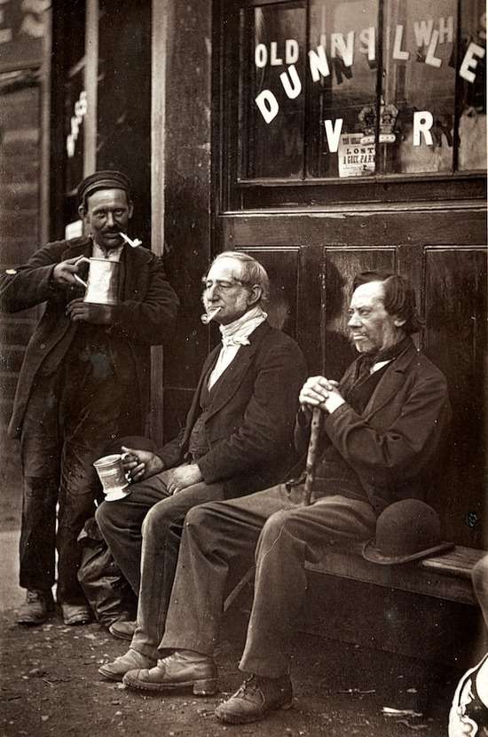 Old Men Smoking and Drinking Alcohol Men from Ellen White's time smoking pipes and drinking beer outside a shop.